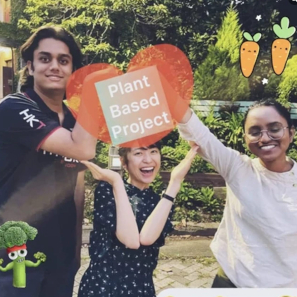 Folks holding a sign that says Plant Based Project