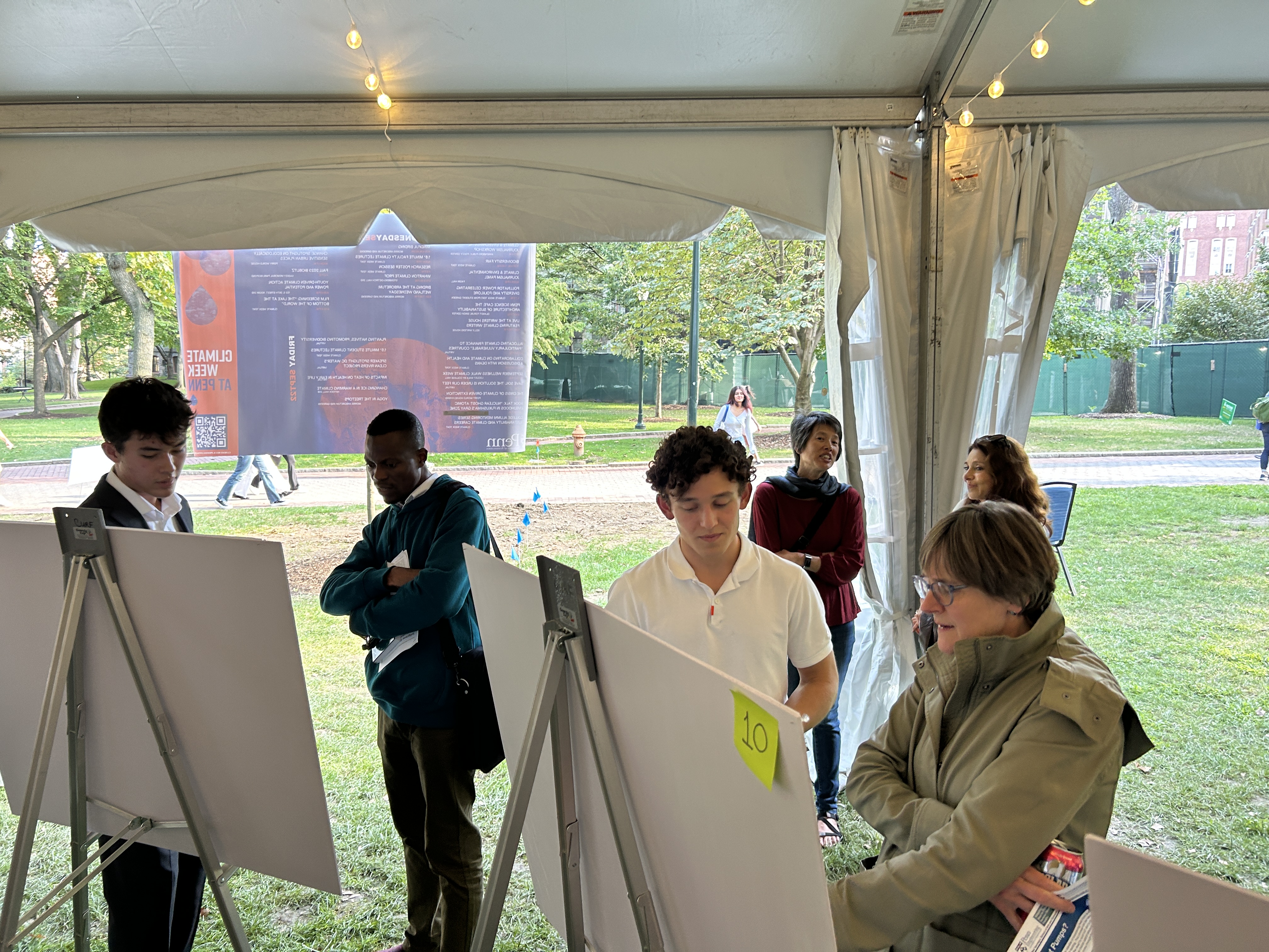 People view posters at a research fair