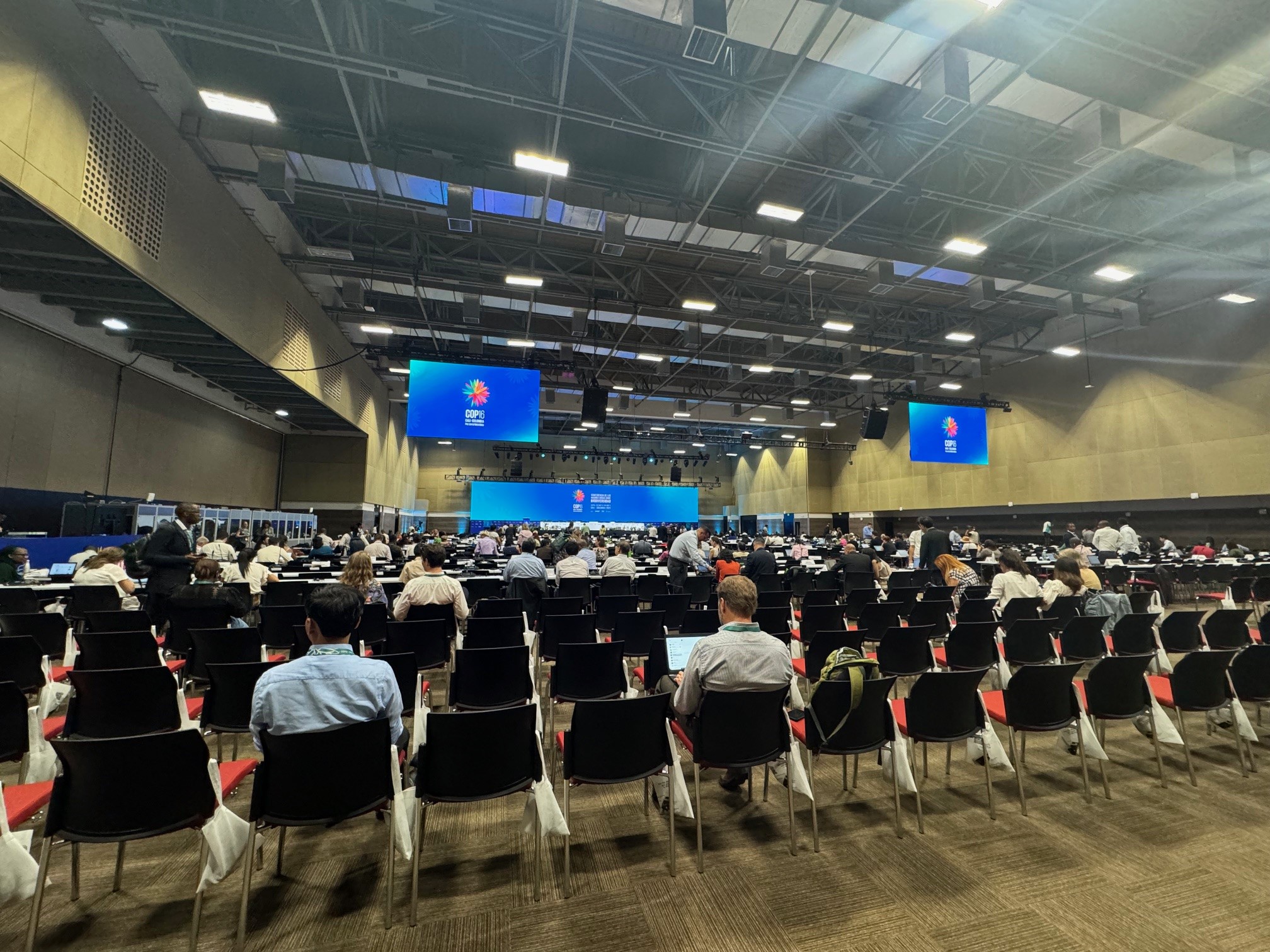 Large conference room with people viewing screens