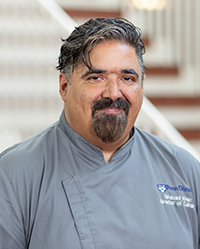 man with grey hair and grey uniform