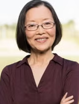 Asian woman in a brown sweater