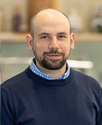man with a beard wearing a blue sweater