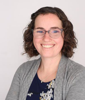 woman with dark hair and eyeglasses