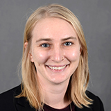 woman with blonde hair in blue top