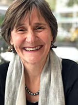 woman with dark hair and grey scarf