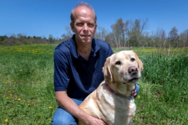 Scott Weese with dog outside