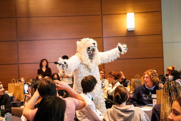 person dressed as a polar bear performs for a crowd