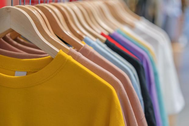 colorful clothes hang on a rack