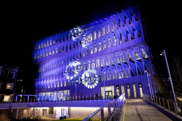 The exterior of the Vagelos building lit up with dramatic lighting.