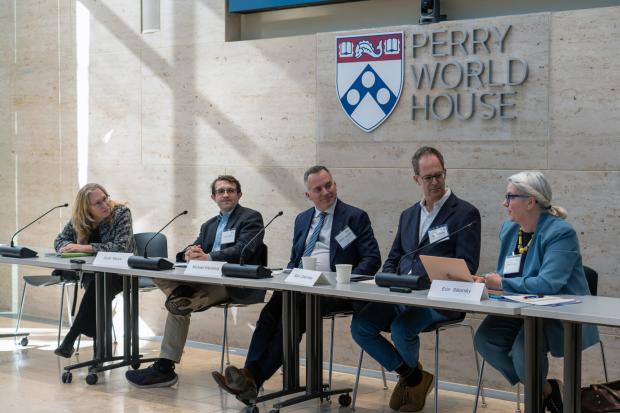 A panel of speakers seated at Perry World House.