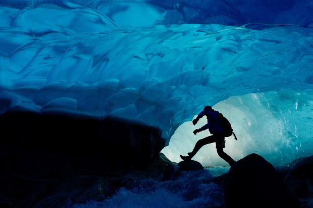 A researcher walking through a glacier in Greenland.