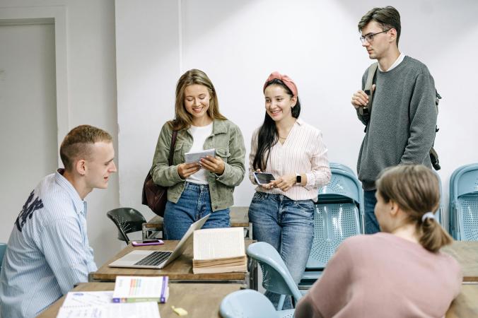 Five students sitting together collaborating