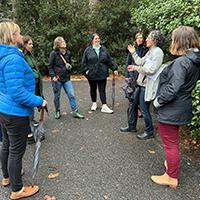 people in a semi circle standing outdoors