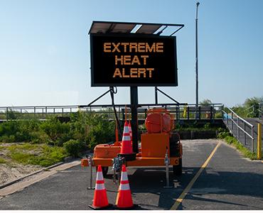 electronic road sign that has extreme heat alert on screen
