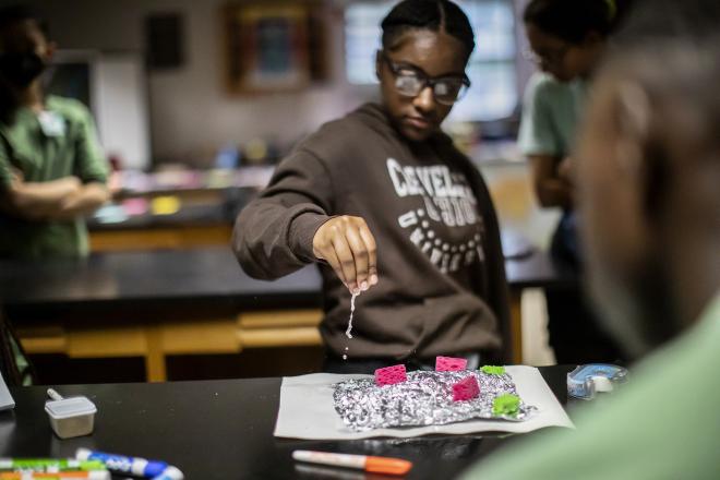 Students from Paul Robeson High School mimicked Philadelphia topography using aluminum foil and pieces of sponge in a hands-on lesson about water quality and hydrology at the Cobbs Creek Community Environmental Education Center. Support from Penn’s Projects for Progress initiative is enhancing the resources the Center uses to run such programming.