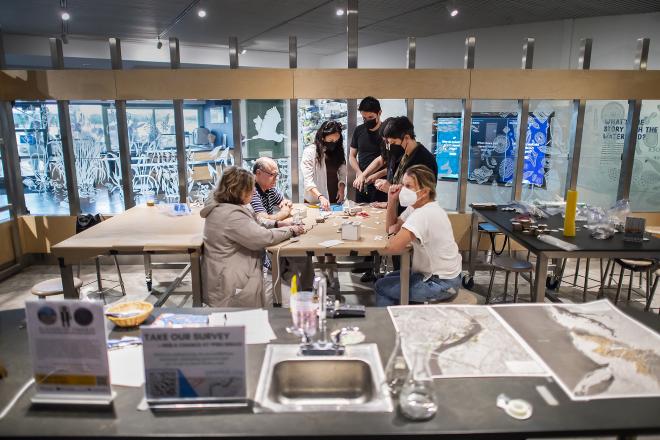 As part of the Penn Program in Environmental Humanities’ Ecotopian Toolkit Project, a “kitbashing” workshop held at the Independence Seaport Museum gave museum visitors an opportunity to imagine and then build structures for a future of higher sea levels and disrupted ecosystems. Juan Hurtado Salazar (standing, in black shirt) was one of five artists and makers supported by the initiative. Among the workshop’s participants was PPEH Founding Director Bethany Wiggin (seated, far right).