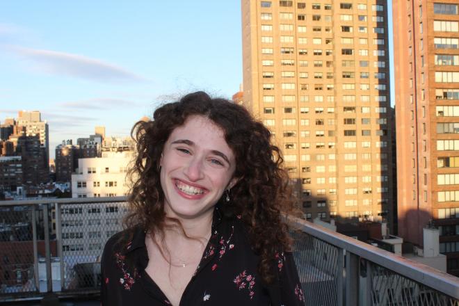 Photo of Sarah Sterinbach on urban rooftop.