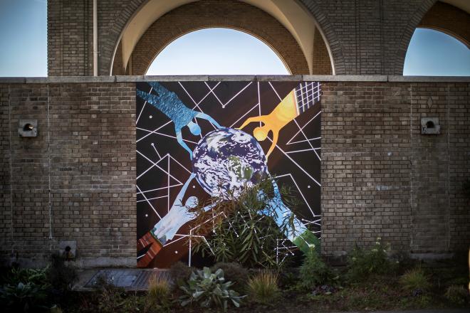 On the boathouse in FDR Park in South Philadelphia, a mural now hangs, a visual representation of United Nations Sustainable Development Goal #7, which is aimed at ensuring access to affordable, reliable, sustainable, modern energy for all. It’s one of 17 such murals in various stages across the city.