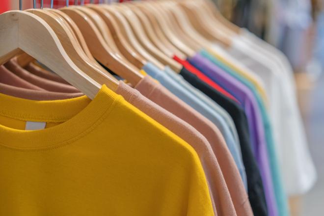 colorful clothes hang on a rack