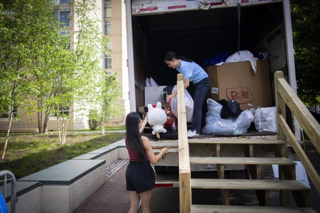 Person gives item to another person staffing donation truck