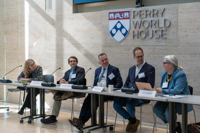 A panel of speakers seated at Perry World House.