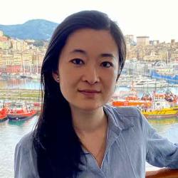 woman with long dark hair wearing a blue blouse