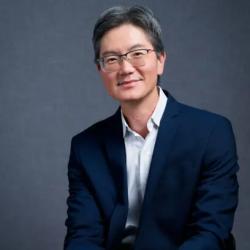 man with glasses in blue jacket