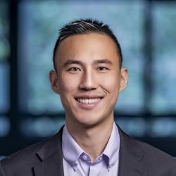 man with short hair and purple shirt