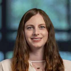 woman with long dark hair and light color blouse