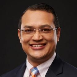 man with glasses and colorful tie