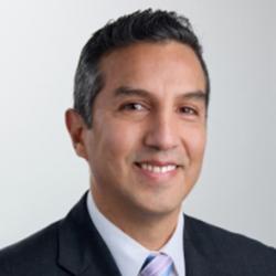 man with short hair and blue tie